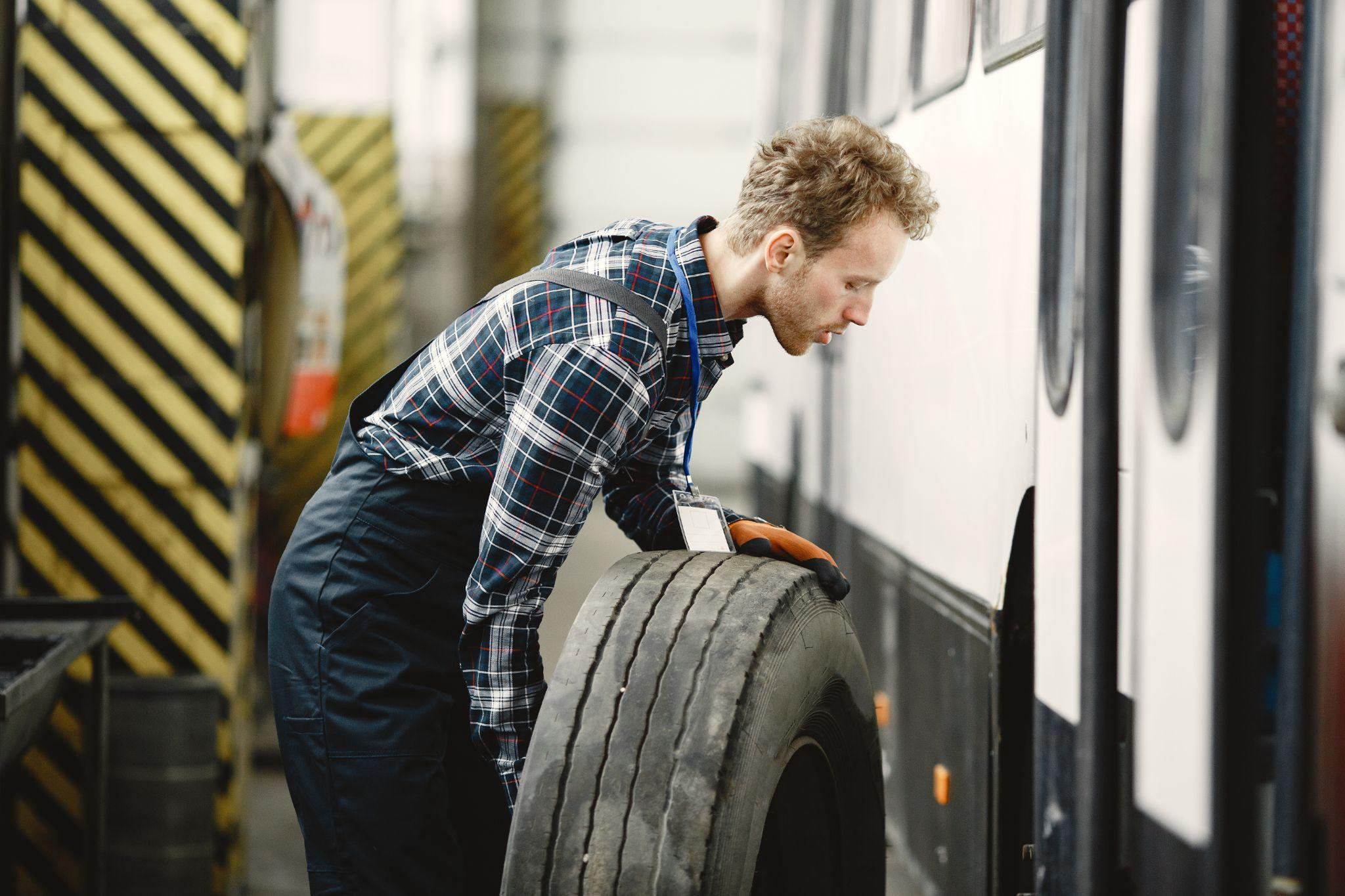 Male mechanic conducting tire replacement
